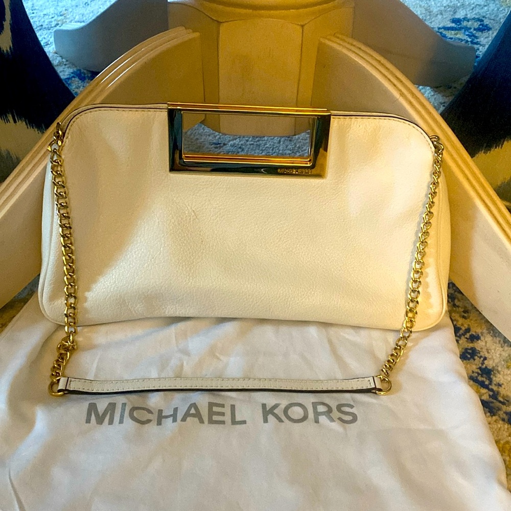Michael’s Kors white purse.  Can use shoulder strap to carry or clutch handle.